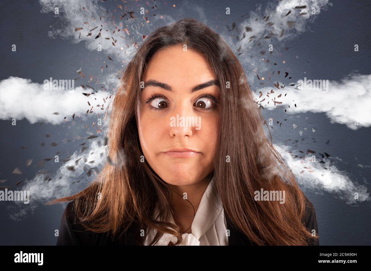 Businesswoman with head ready to explode due to stress and overwork Stock Photo