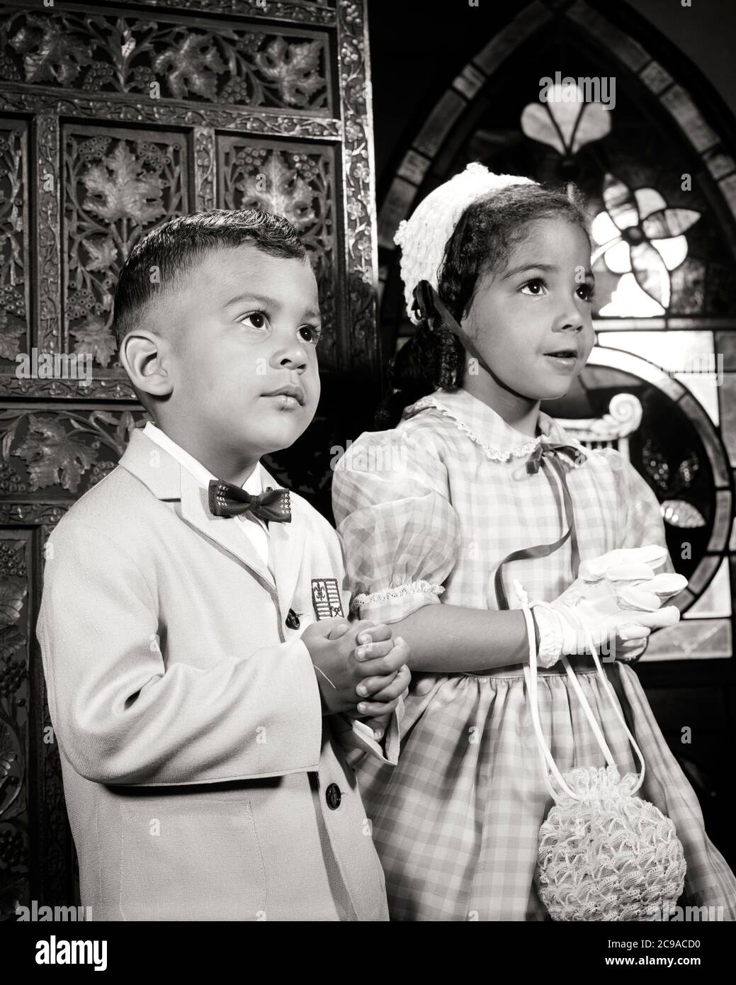 1960s TWO WELL DRESSED AFRICAN-AMERICAN CHILDREN BOY GIRL SISTER BROTHER ATTENDING CHURCH PRAYING TOGETHER - n1730 HAR001 HARS FEMALES SUNDAY BROTHERS PRAYER HOME LIFE COPY SPACE HALF-LENGTH INSPIRATION CARING MALES CHRISTIAN SIBLINGS SPIRITUALITY SISTERS B&W DREAMS HAPPINESS RELIGIOUS AFRICAN-AMERICANS AFRICAN-AMERICAN CHRISTIANITY PRAY BLACK ETHNICITY PRIDE SIBLING CONCEPTUAL STYLISH FAITHFUL FAITH GROWTH JUVENILES SPIRITUAL TOGETHERNESS BELIEF BLACK AND WHITE HAR001 INSPIRATIONAL OLD FASHIONED AFRICAN AMERICANS Stock Photo