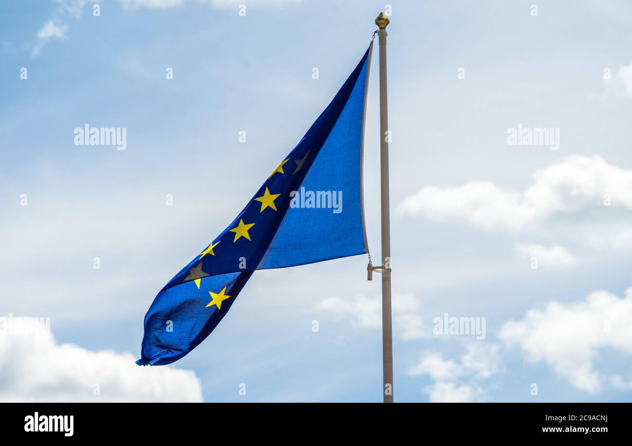 European Union flag on a flagpole against the sky with clouds Stock ...