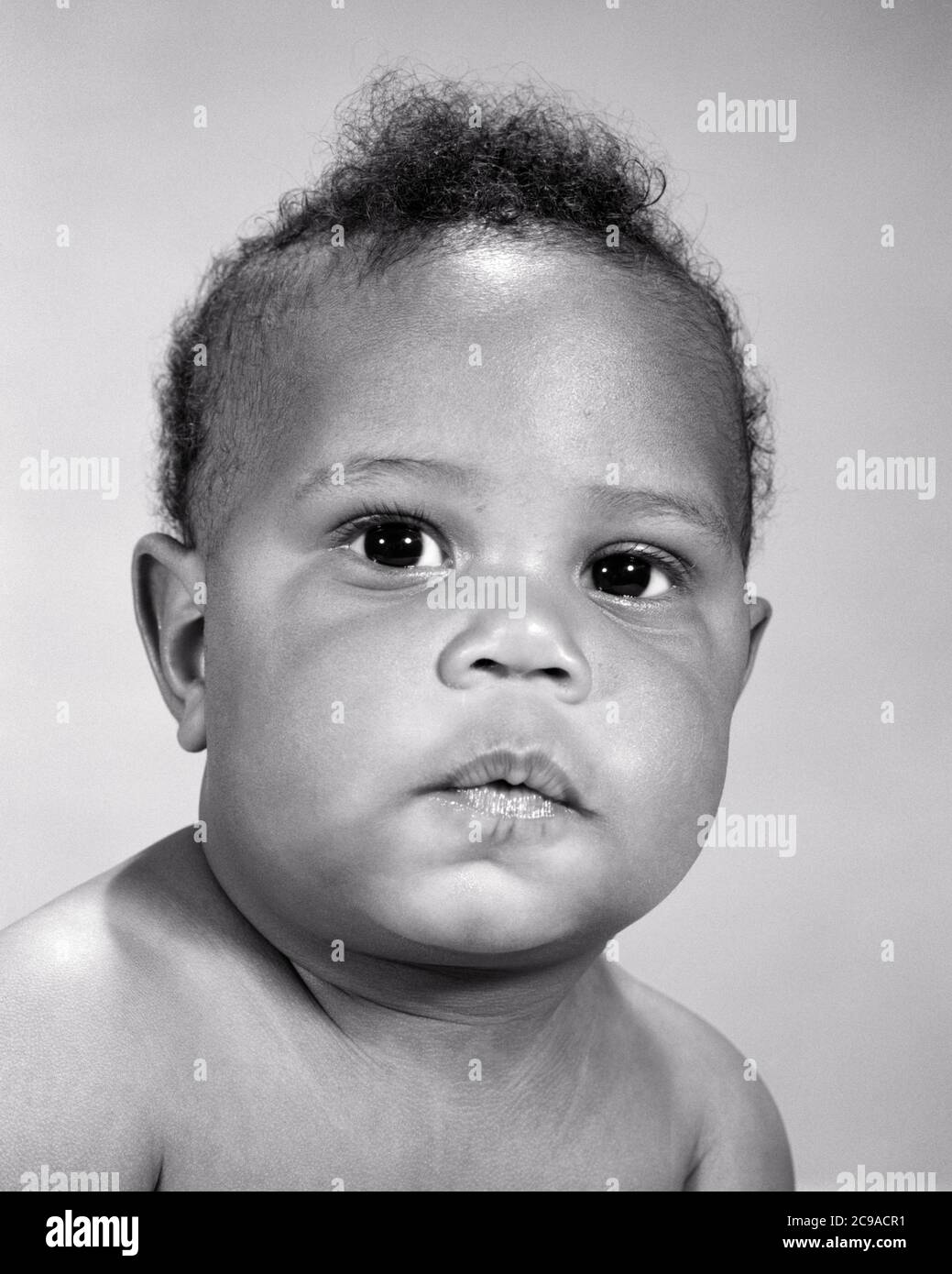 1960s PORTRAIT OF SERIOUS AFRICAN AMERICAN BABY BOY WITH POUTING QUESTIONING FACIAL EXPRESSION LOOKING AT CAMERA - n2168 HAR001 HARS EXPRESSIONS B&W SADNESS EYE CONTACT HEAD AND SHOULDERS POUTING AFRICAN-AMERICANS AFRICAN-AMERICAN CHEEKS BLACK ETHNICITY CONCEPTUAL SINCERE BABY BOY SOLEMN FOCUSED GROWTH INTENSE JUVENILES QUESTIONING BLACK AND WHITE CAREFUL EARNEST HAR001 INTENT OLD FASHIONED AFRICAN AMERICANS Stock Photo