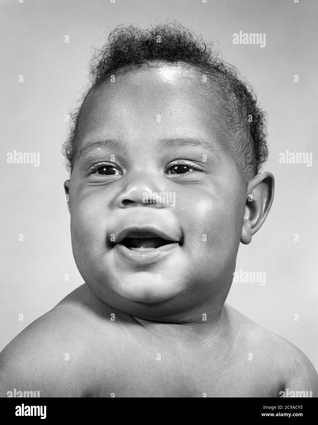 1960s PORTRAIT OF HAPPY AFRICAN-AMERICAN BABY BOY WITH CHUBBY CHEEKS SMILING LOOKING OFF CAMERA - n2174 HAR001 HARS STUDIO SHOT HEALTHINESS HOME LIFE COPY SPACE MALES CHUBBY EXPRESSIONS B&W HAPPINESS HEAD AND SHOULDERS CHEERFUL AFRICAN-AMERICANS AFRICAN-AMERICAN CHEEKS EXCITEMENT BLACK ETHNICITY OF SMILES CONNECTION CONCEPTUAL JOYFUL BABY BOY COOPERATION GROWTH JUVENILES BLACK AND WHITE HAR001 OLD FASHIONED AFRICAN AMERICANS Stock Photo