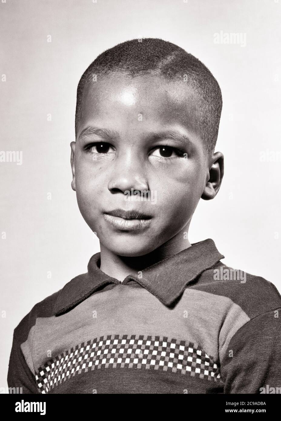 1940s PORTRAIT AFRICAN-AMERICAN BOY LOOKING AT CAMERA SERIOUS FACIAL EX[RESSION - n670 HAR001 HARS HEALTHINESS HOME LIFE COPY SPACE THOUGHTFUL MALES RISK SPIRITUALITY CONFIDENCE EXPRESSIONS TROUBLED B&W CONCERNED SADNESS EYE CONTACT DREAMS WELLNESS HEAD AND SHOULDERS AFRICAN-AMERICANS AFRICAN-AMERICAN BLACK ETHNICITY DIRECTION PRIDE OPPORTUNITY MOOD CONCEPTUAL GLUM SINCERE SOLEMN FOCUSED GROWTH INTENSE JUVENILES MISERABLE BLACK AND WHITE CAREFUL EARNEST HAR001 INTENT OLD FASHIONED AFRICAN AMERICANS Stock Photo