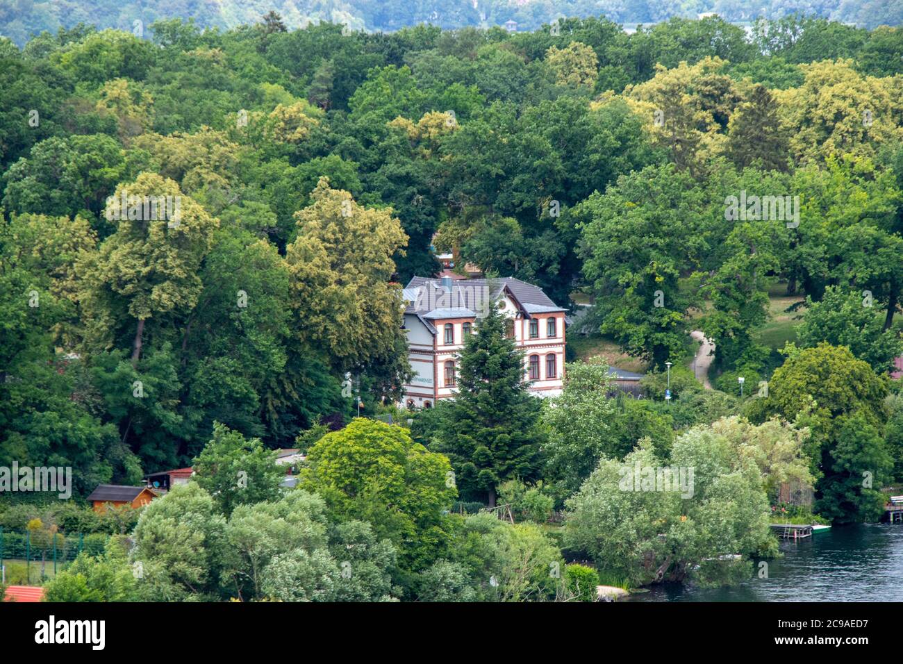 Aerial view of a house in a forest surrounded by tall trees Stock Photo ...