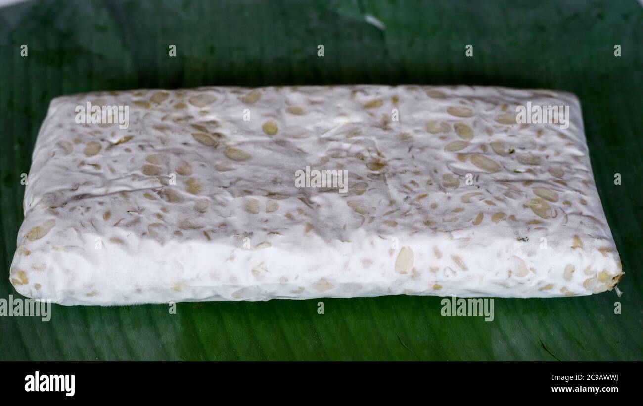 Raw tempeh on banana leaf. Tempeh is a traditional soy product