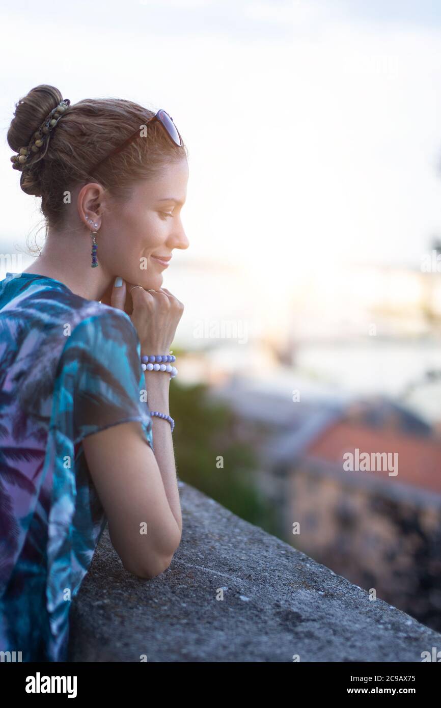 Young 20s urban adult woman daydreaming about love outdoors Stock Photo
