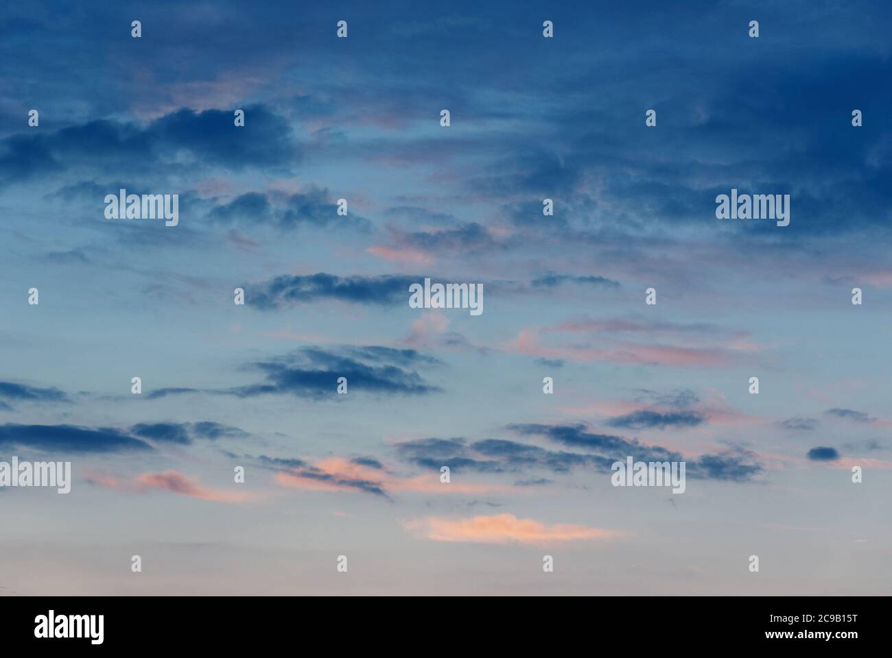 dark blue random clouds in evening sky, dusk sky background Stock Photo