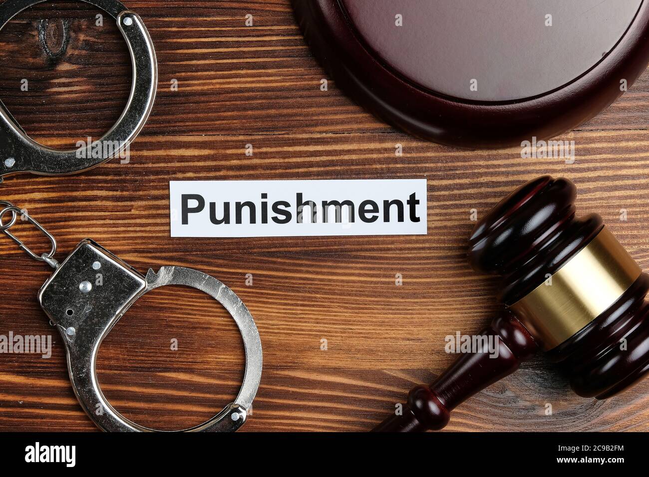 Punishment concept on sticker next to judge's handcuffs and hammer ...