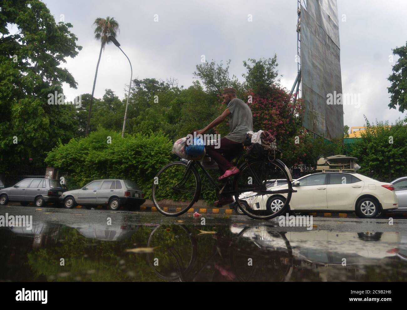Lahore, Pakistan. 29th July, 2020. Pakistani motorists are on their way during the monsoon rain spell in Lahore. (Photo by Rana Sajid Hussain/Pacific Press) Credit: Pacific Press Media Production Corp./Alamy Live News Stock Photo