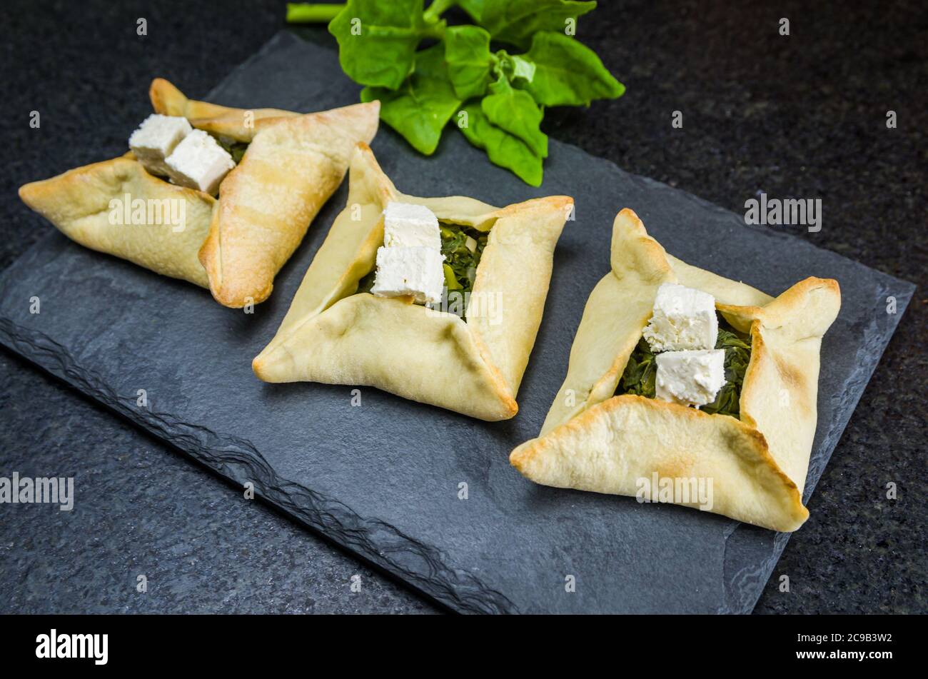 Delicious Lebanese (Arabic) food, spinach sfiha with ricotta cheese on