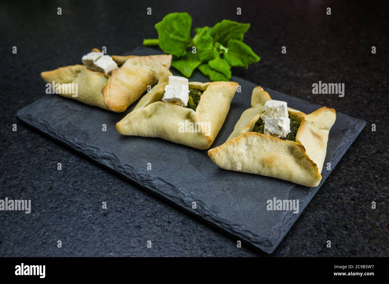 Delicious Lebanese (Arabic) food, spinach sfiha with ricotta cheese on