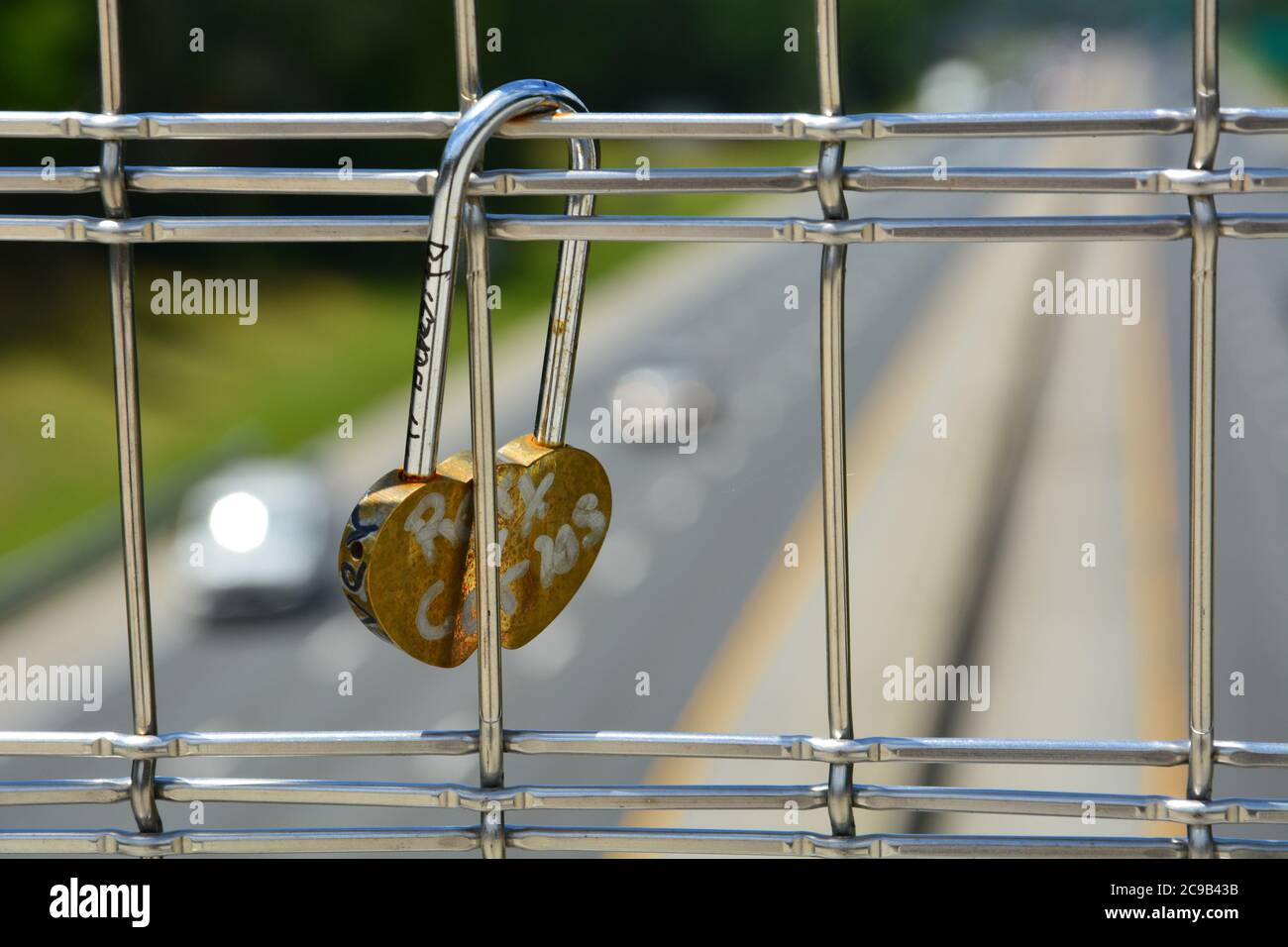 Love locks have started to accumulate on the American Tobacco Trail bridge over Interstate 40 in Durham, NC. Stock Photo