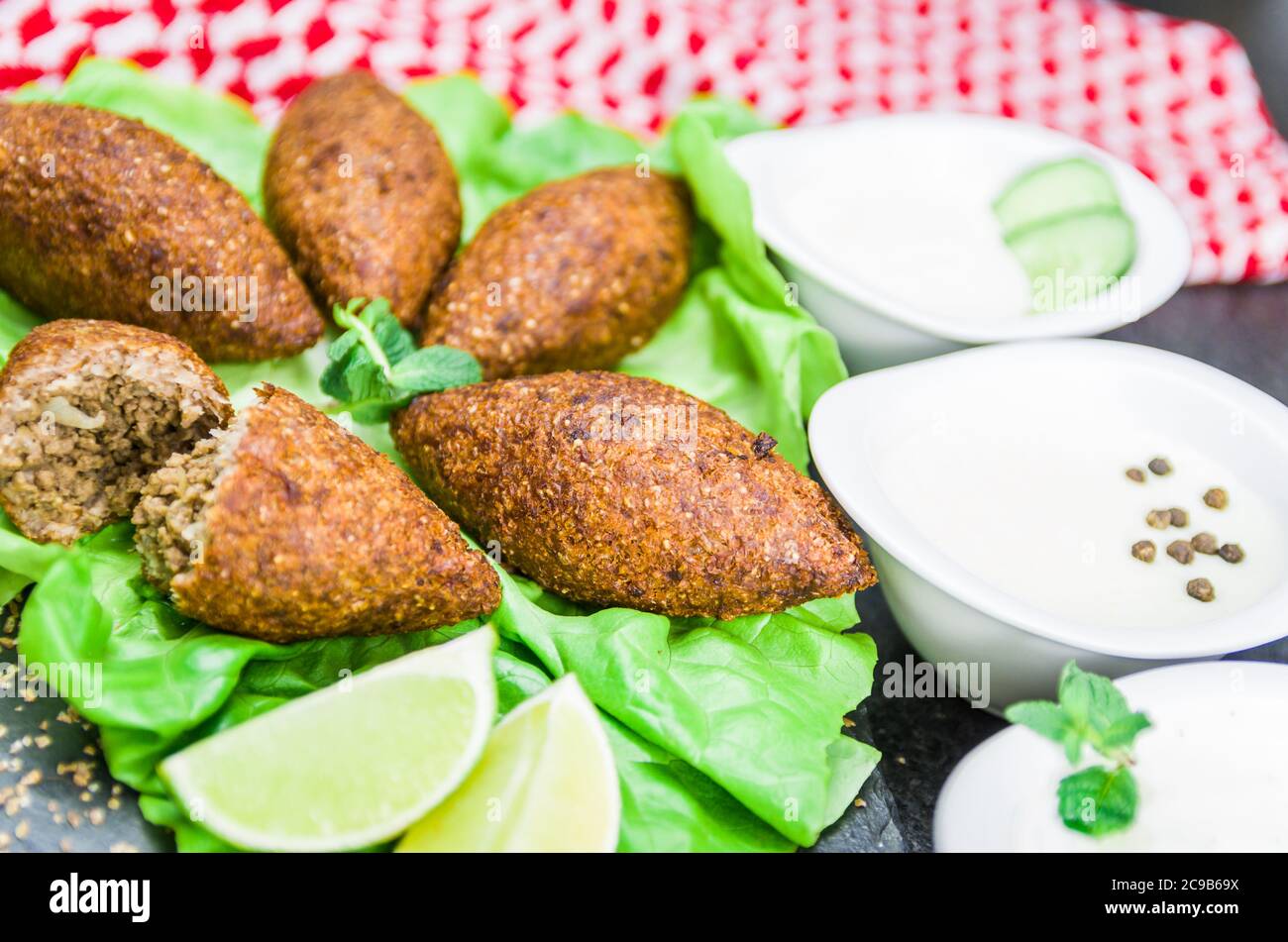 Delicious Lebanese (Arabic) food, kibbeh (kibe) with sauces and lemon