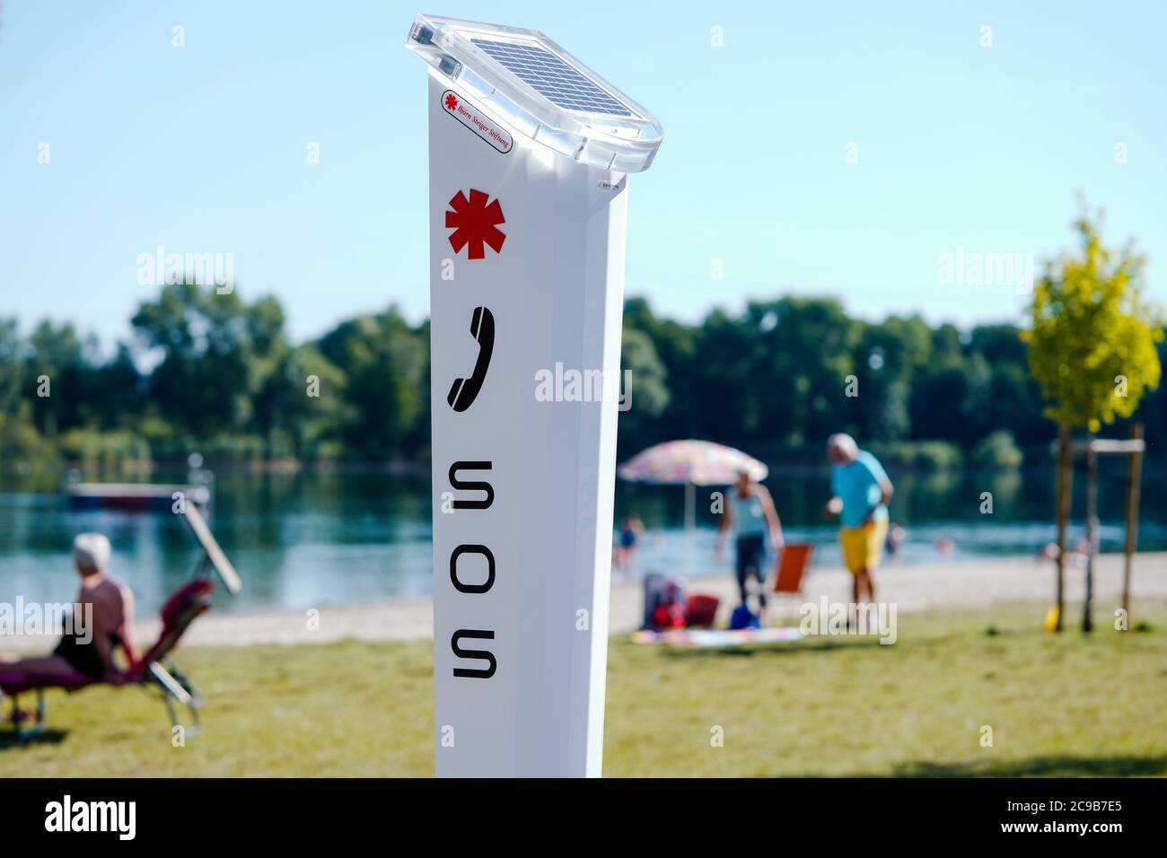 Jockgrim, Germany. 29th July, 2020. An emergency call point of the Björn Steiger Foundation and the German Life Saving Society (DLRG) is located in the Johanneswiesen recreation area at the Jockgrim quarry pond. Credit: Uwe Anspach/dpa/Alamy Live News Stock Photo