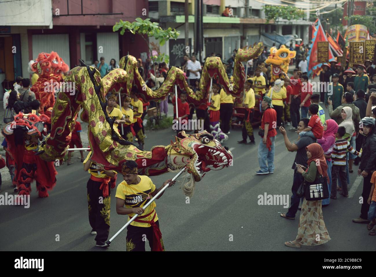A Chinese dragon dance team parades during the 2015 Bandung Lantern Festival Cultural Parade (Kirab Budaya Cap Go Meh Bandung 2015) in Bandung City, Indonesia. Stock Photo
