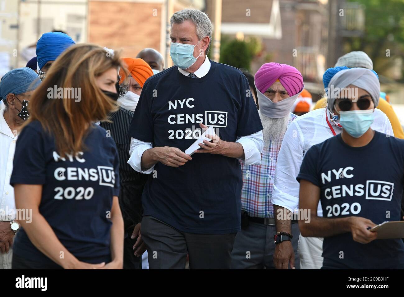 New York City, USA. 29th July, 2020. New York City Mayor Bill de Blasio (c) and NYC Census 20202 Director Julie Menin (l) walk through the Richmond Hill Indian Punjabi community as they go door-knocking to encourage New Yorkers to complete the 2020 census, in Queens, NY, July 29, 2020. (Anthony Behar/Sipa USA) Credit: Sipa USA/Alamy Live News Stock Photo