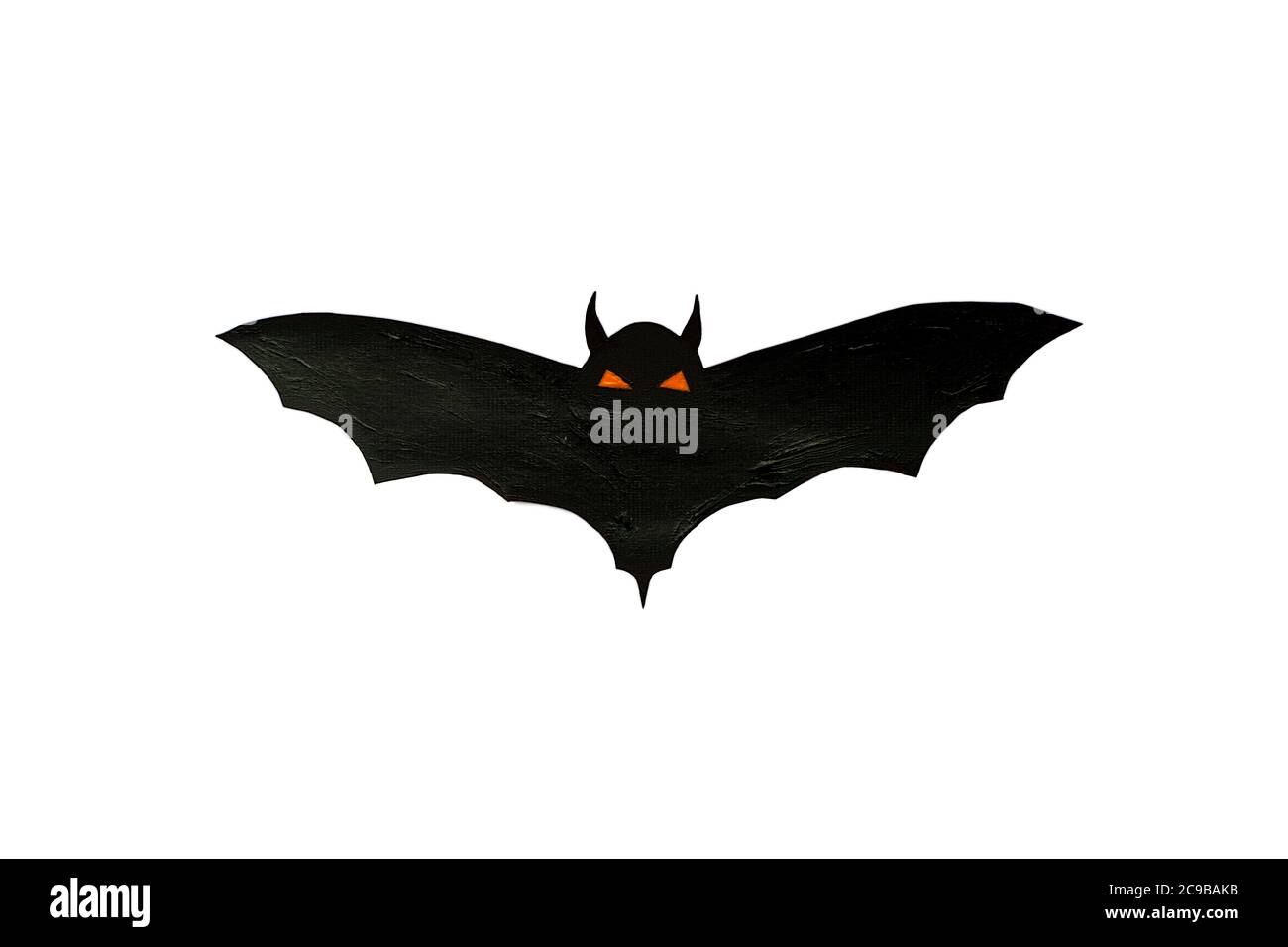 Carved scary figurine of bat on a white background, the concept of the holiday Halloween Stock Photo