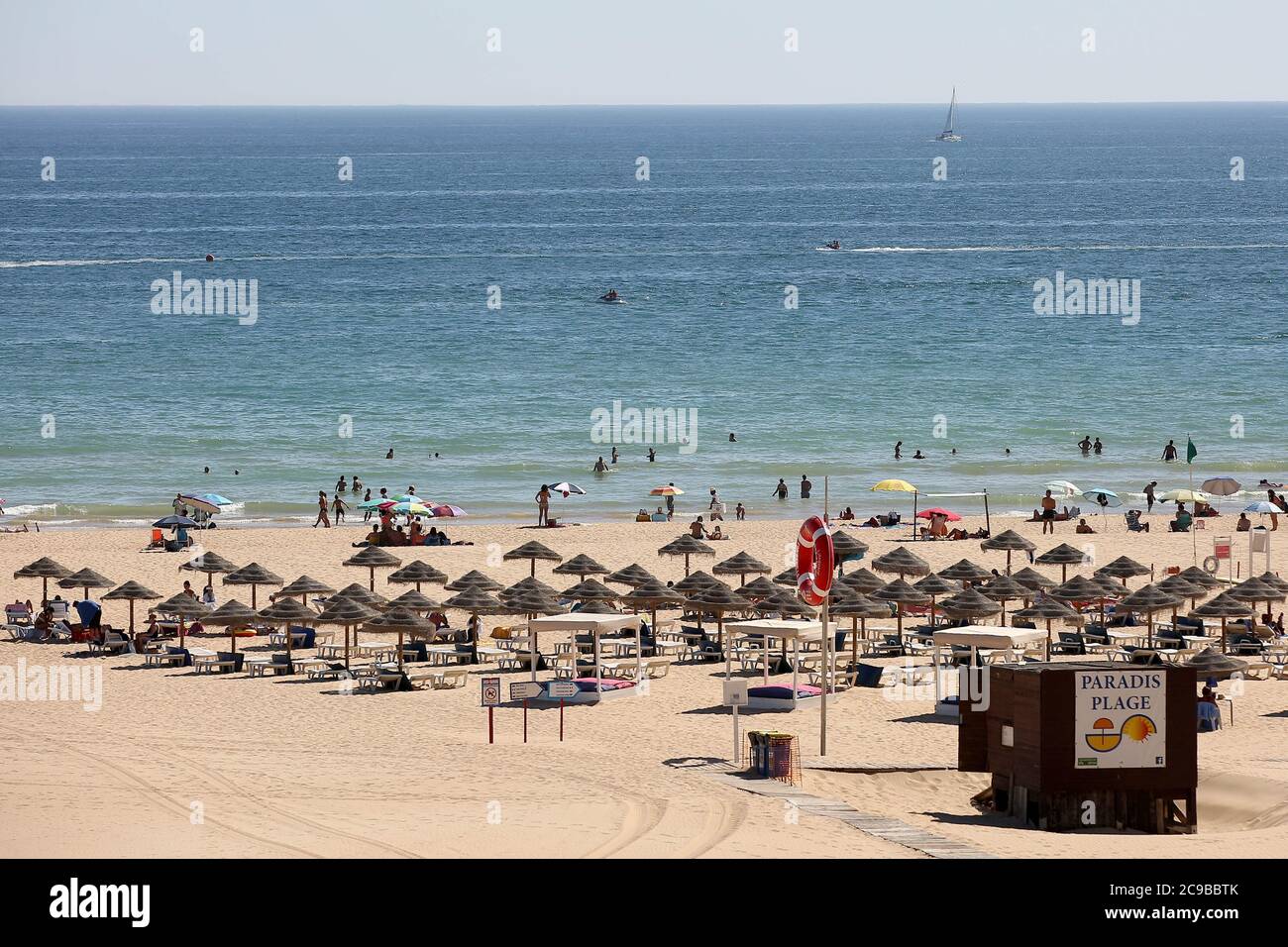 Algarve, Portugal. 29th July, 2020. Beachgoers sunbathe and swim at a beach in Portimao, Algarve region, Portugal on July 29, 2020. Portuguese President Marcelo Rebelo de Sousa has promised to visit the Algarve every week this summer to help the regionÃs struggling tourism sector overcome the effects of the Covid-19 pandemic and the UK governmentÃs decision to include mainland Portugal in its Ã”travel blacklistÃ Credit: Pedro Fiuza/ZUMA Wire/Alamy Live News Stock Photo