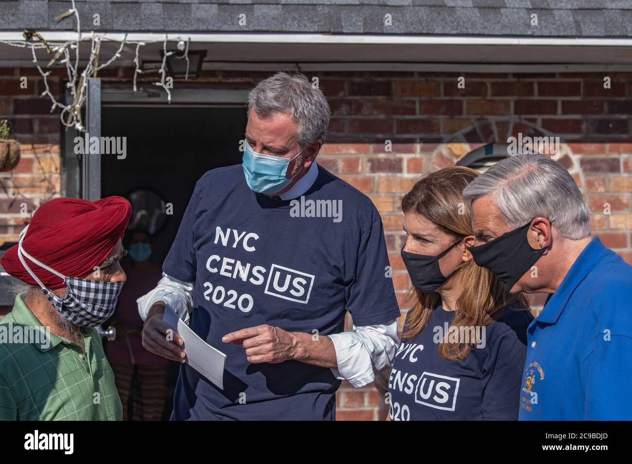 New York, United States. 29th July, 2020. Mayor Bill de Blasio, NYC Census 2020 Director Julie Menin and Assembly Member David Weprin talk to Mr. Singh in Queens borough, New York City.Mayor Bill de Blasio and NYC Census 2020 Director Julie Menin go door-knocking to encourage New Yorkers to complete the census in South Richmond Hill, Queens. Credit: SOPA Images Limited/Alamy Live News Stock Photo