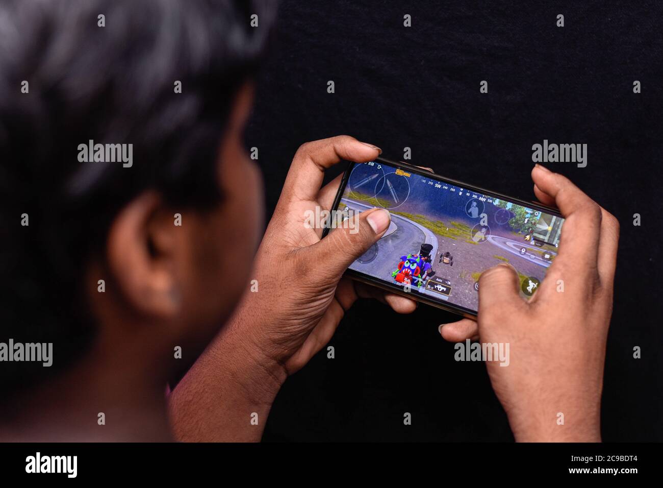 In this photo illustration, a boy playing PUBG on his smartphone. Indian government is considering a ban on the battle royale format games over data security concerns. Stock Photo