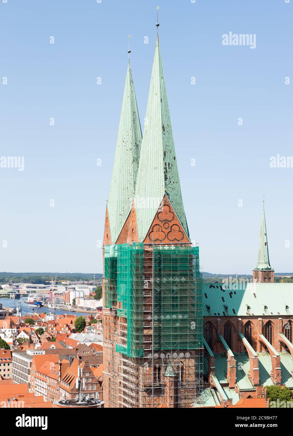 Lübeck, Schleswig-Holstein - June 23, 2020: Close up of the two towers of the Marienkirche. Historical church with scaffolding. Portrait format. Stock Photo