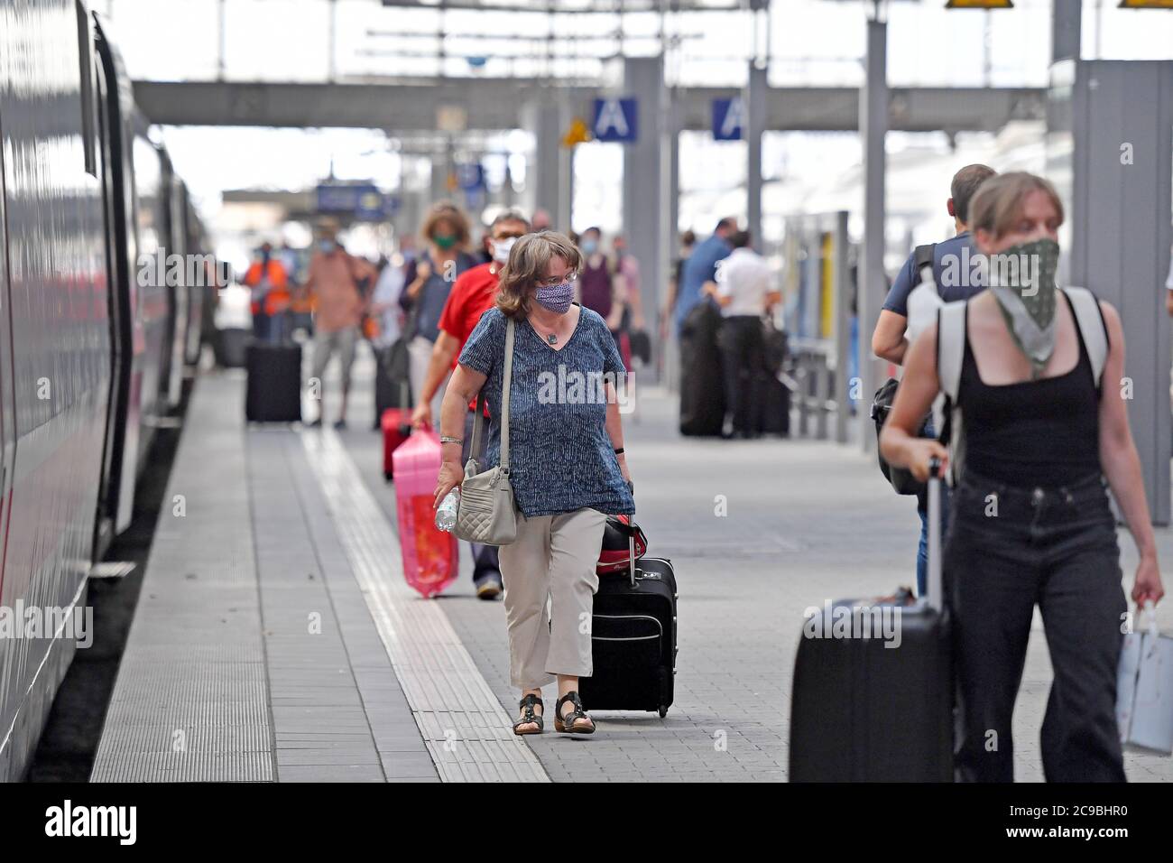 Mask requirement public transport. Munich Central Station on July 2020. Passengers go with a face mask, mask after the arrival of a train on the platform. Mouth-nose protection.Mun protection, mask,