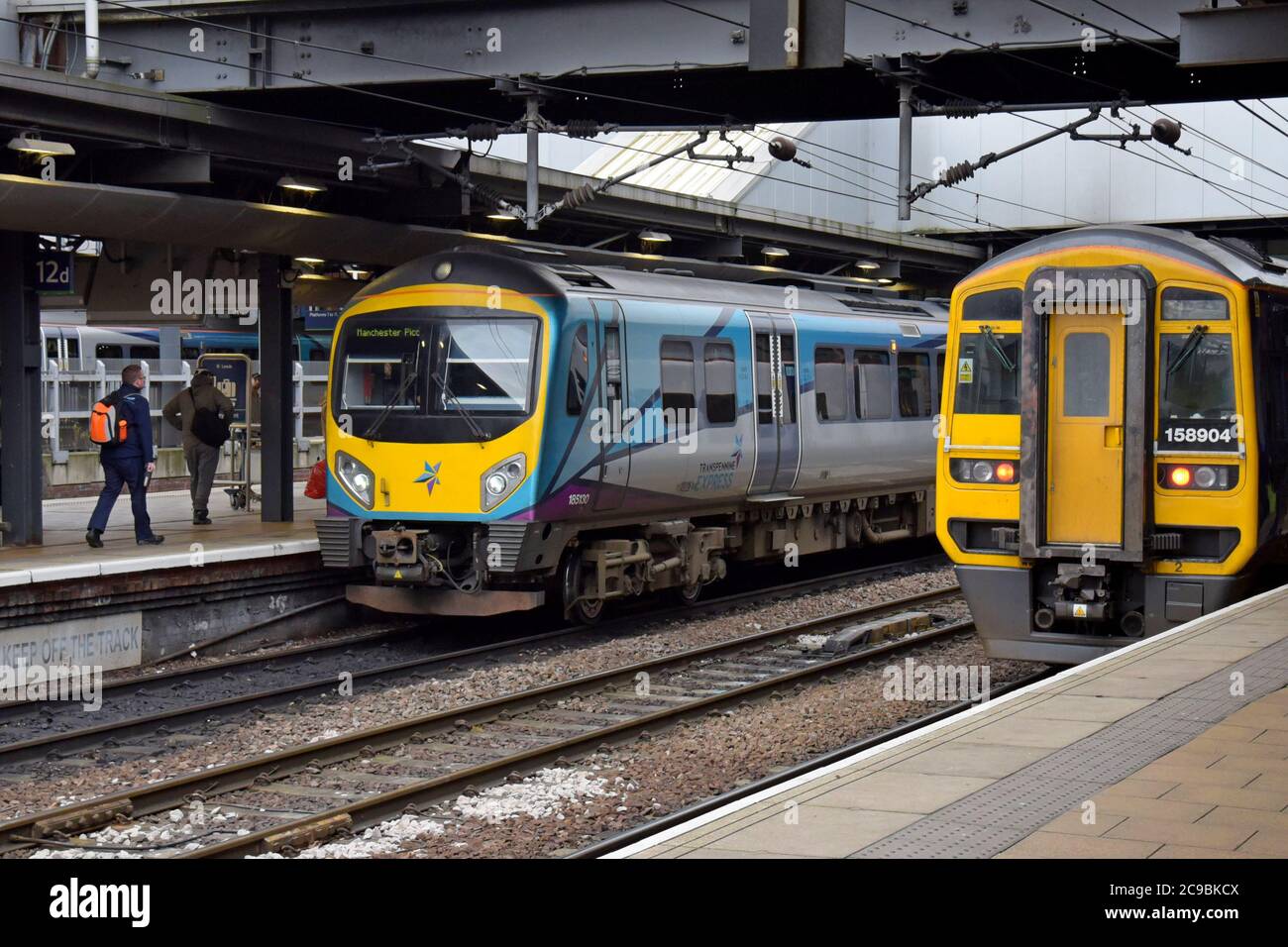 A TransPennine Express Class 185 Desiro DMU sits alongside a Northern Trains Class 158 Express DMU at Leeds station Stock Photo