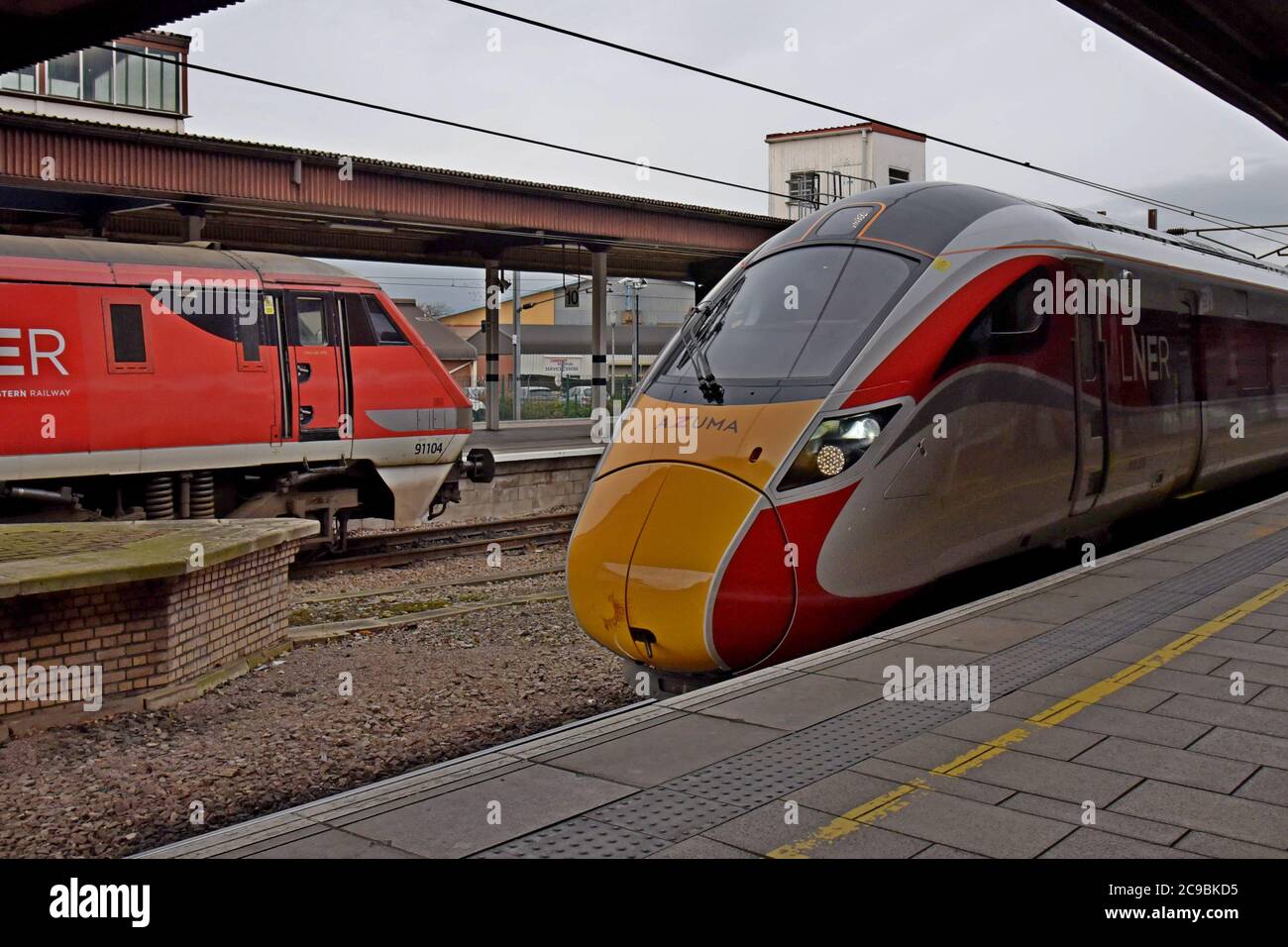 LNER Electric locomotive 91104 and new Azuma High Speed Train waiting at platforms in York Station Stock Photo