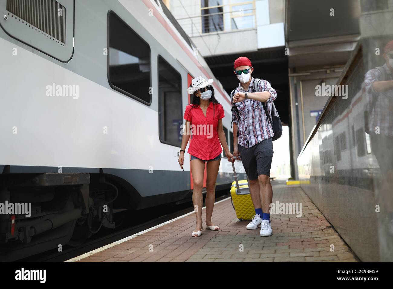 Passengers go with a suitcase to board the train Stock Photo Alamy