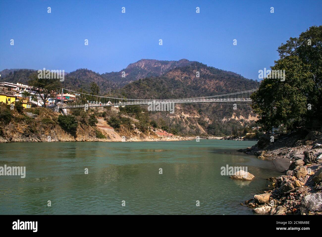 Ram Jhula is a suspension bridge across the river Ganges, Rishikesh and Haridwar are popular tourist destination termed as twin heritage cities Stock Photo