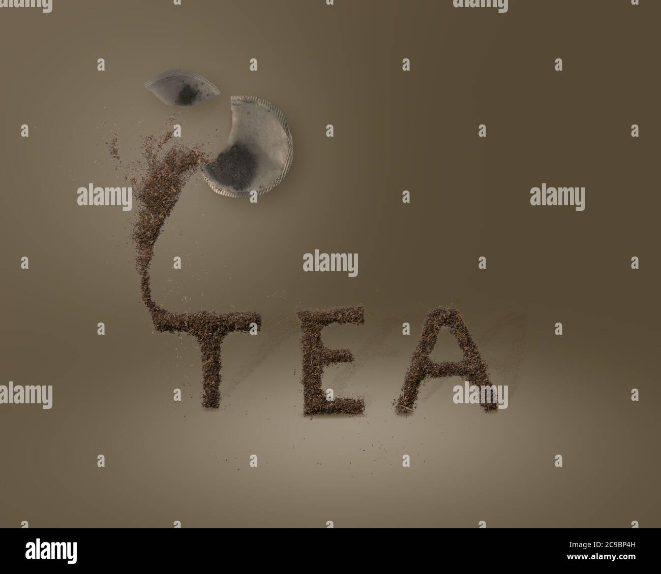A ripped tea bag pouring tea leaves out to spell the word TEA Stock