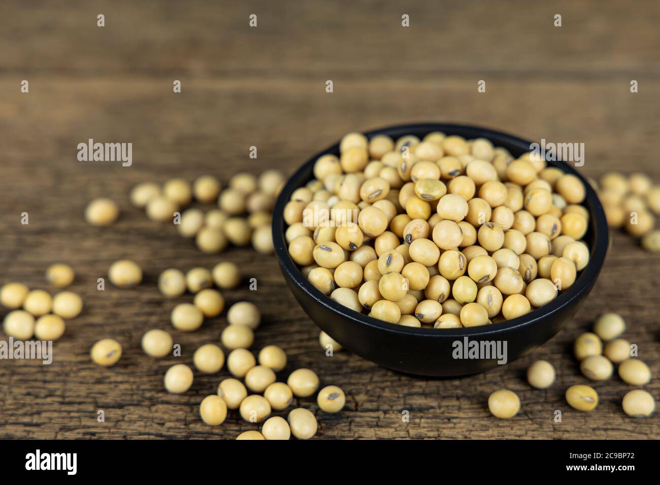 Raw soybeans in wooden bowl on wooden table background Stock Photo Alamy