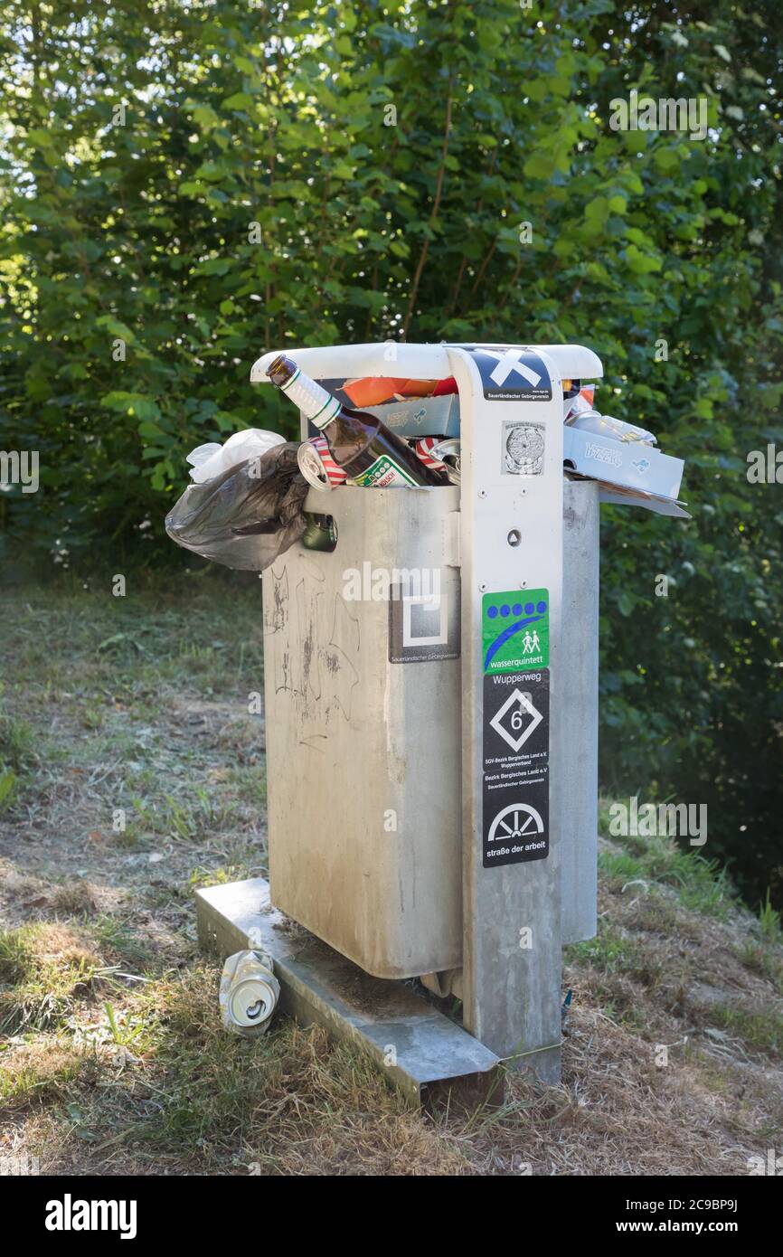 Overfull waste bin in a public park in Wipperfürth, Germany Stock Photo ...