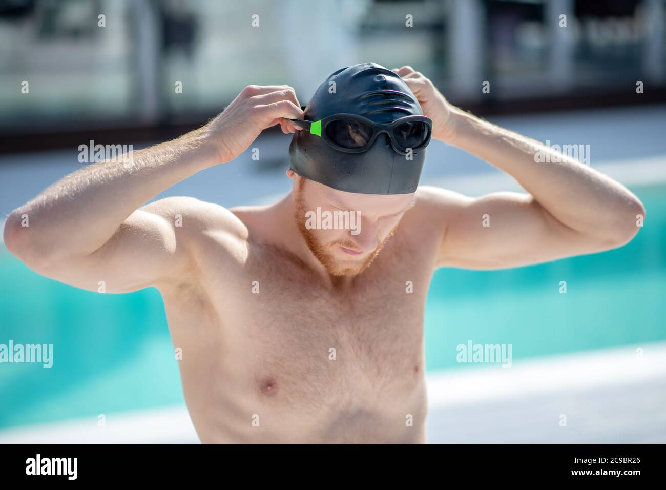 Man in swimming cap wearing swimming goggles. Stock Photo