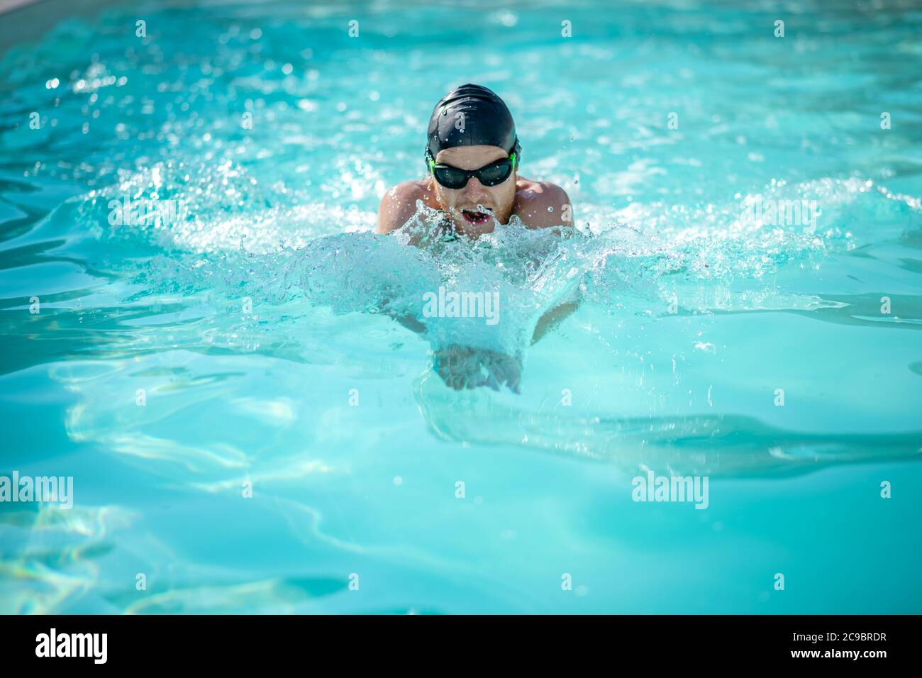 Swimmer moving forward with open mouth in water Stock Photo - Alamy