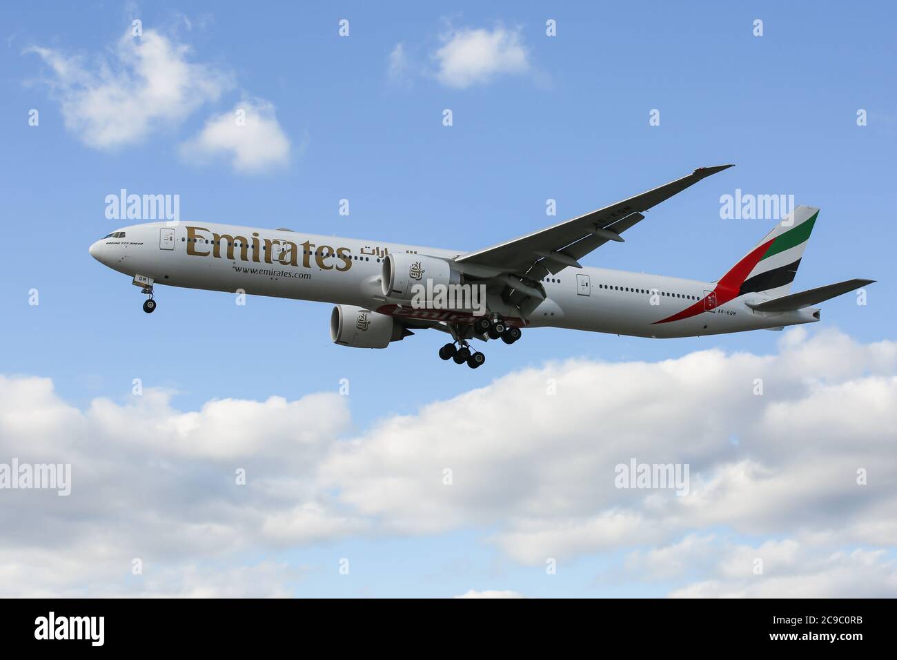 A Boeing 777-31H(ER) flying for Emirates lands at London Heathrow Airport Stock Photo