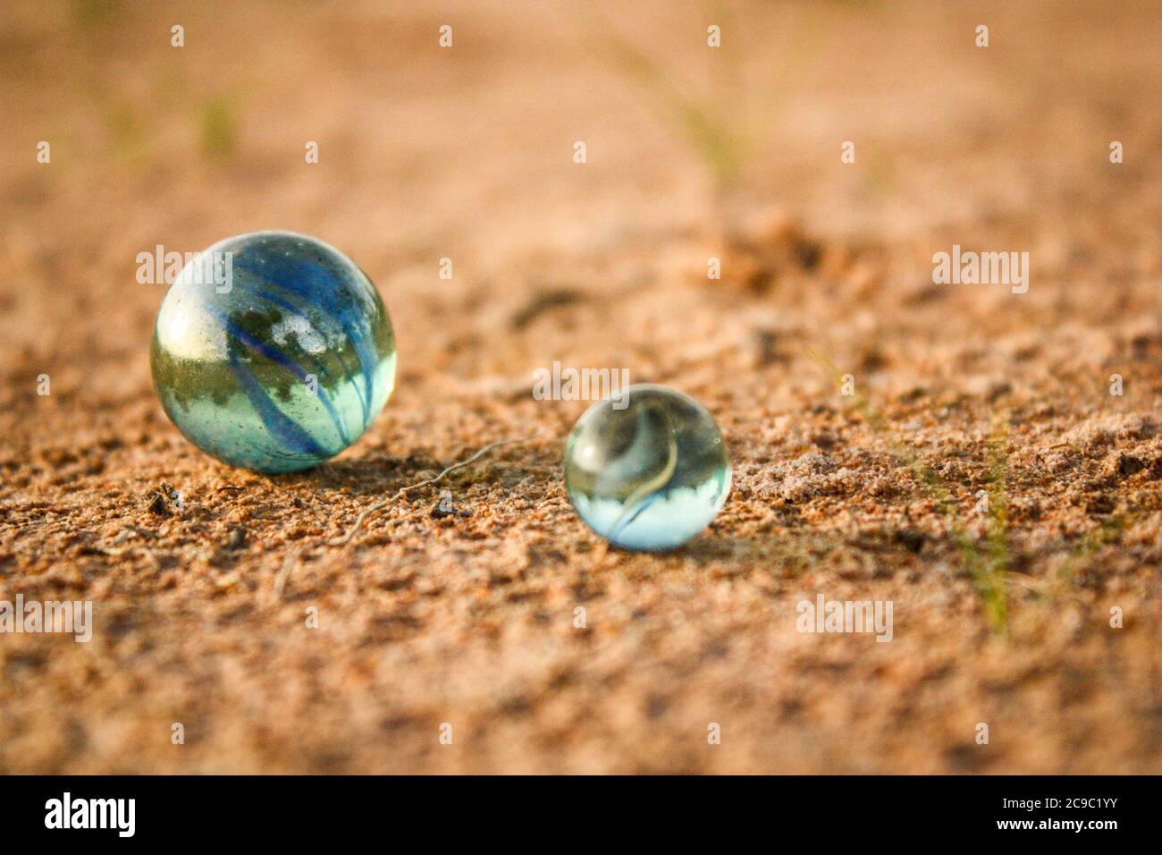 you can see two marbles on a sandy floor Stock Photo