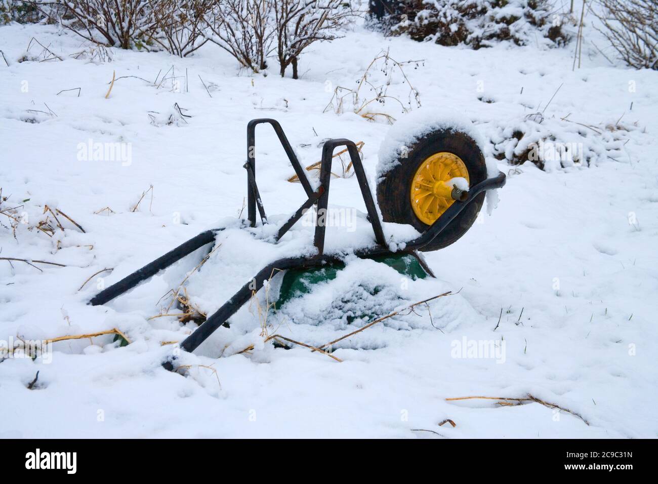 Wheelbarrow covered in snow hi res stock photography and images