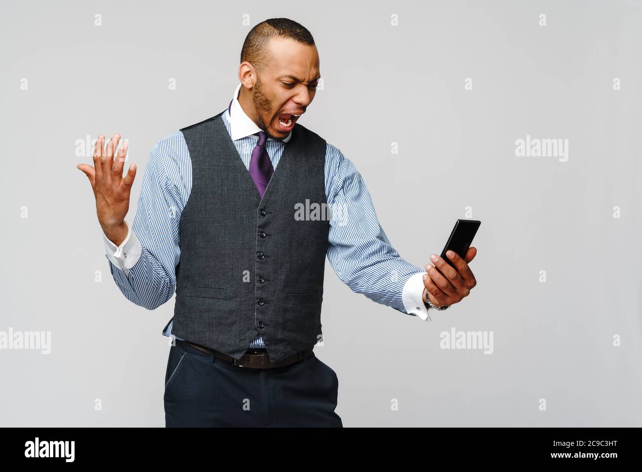 african-american business man talking on mobile phone - stress and negativity Stock Photo