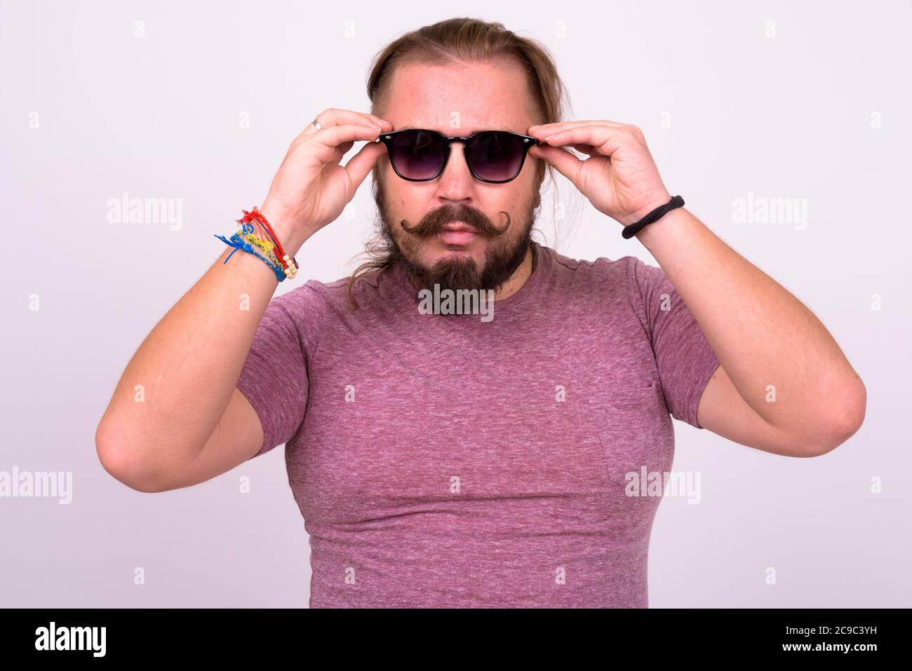 Bearded man with mustache and long hair against white background Stock Photo