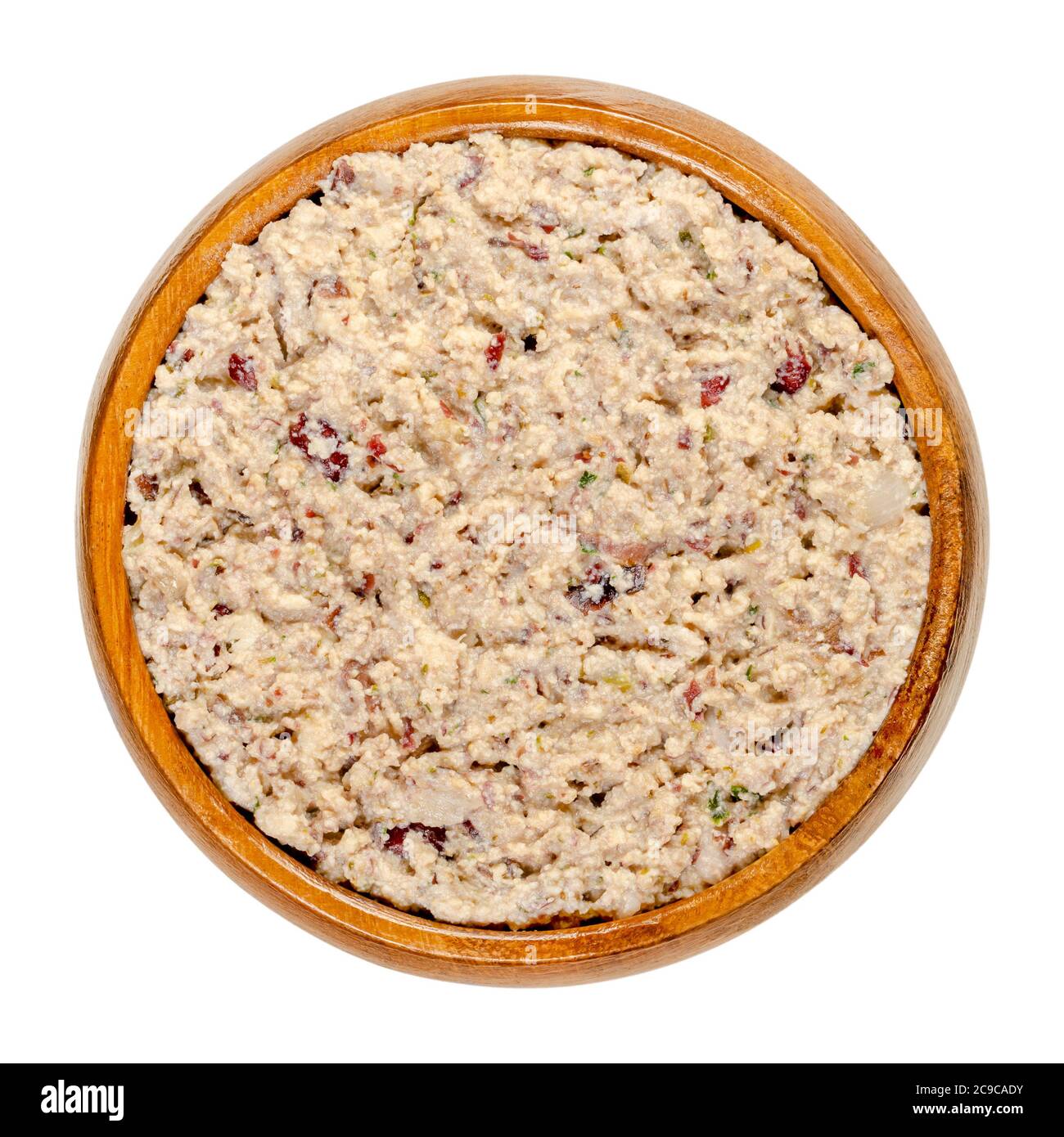 Vegan spread in a wooden bowl. Made of smoked tofu, kidney beans, roasted onions, herbs, salt and pepper. Paste that can be spread onto bread. Stock Photo