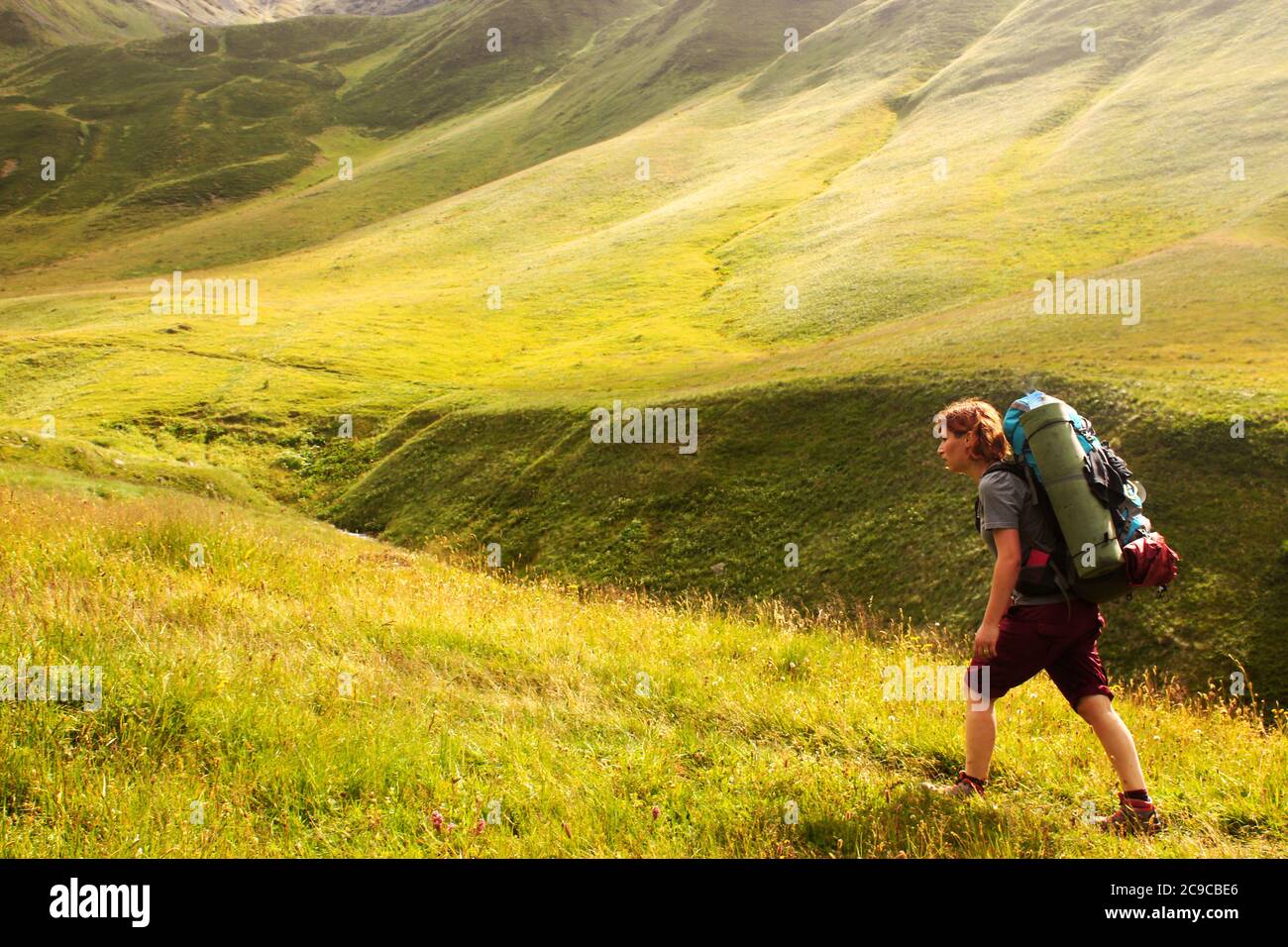 Hiker on the mountain landscape background, young girl backpacker in ...
