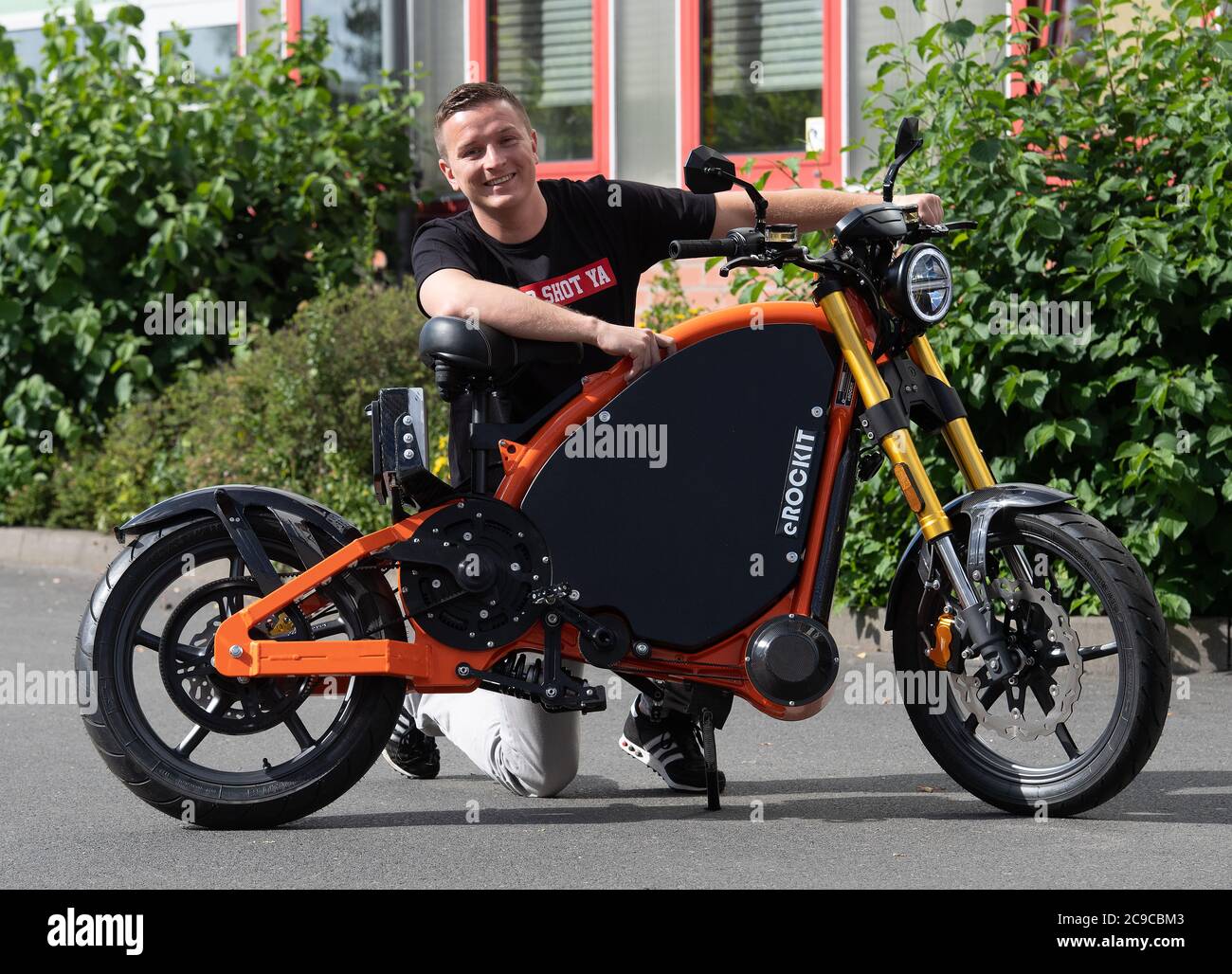 Hennigsdorf Germany. 30th July 2020. Influencer and presenter Aaron Troschke kneels behind a pedal controlled electric