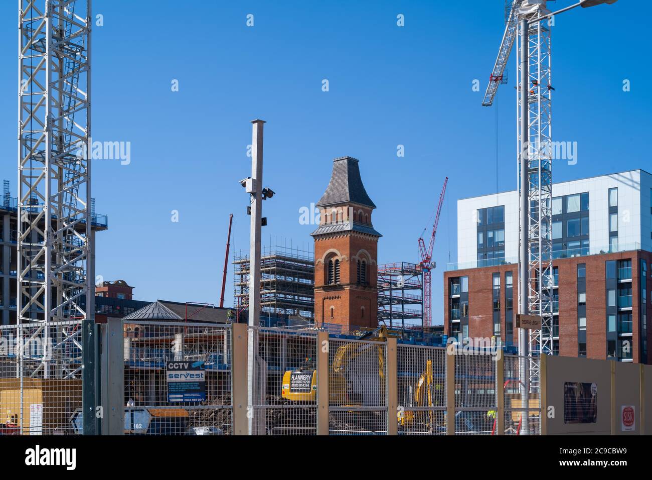 Building development encroaches on St Peter's Church in Ancoats, Manchester. Photo features The Ice Plant apartment block. Stock Photo