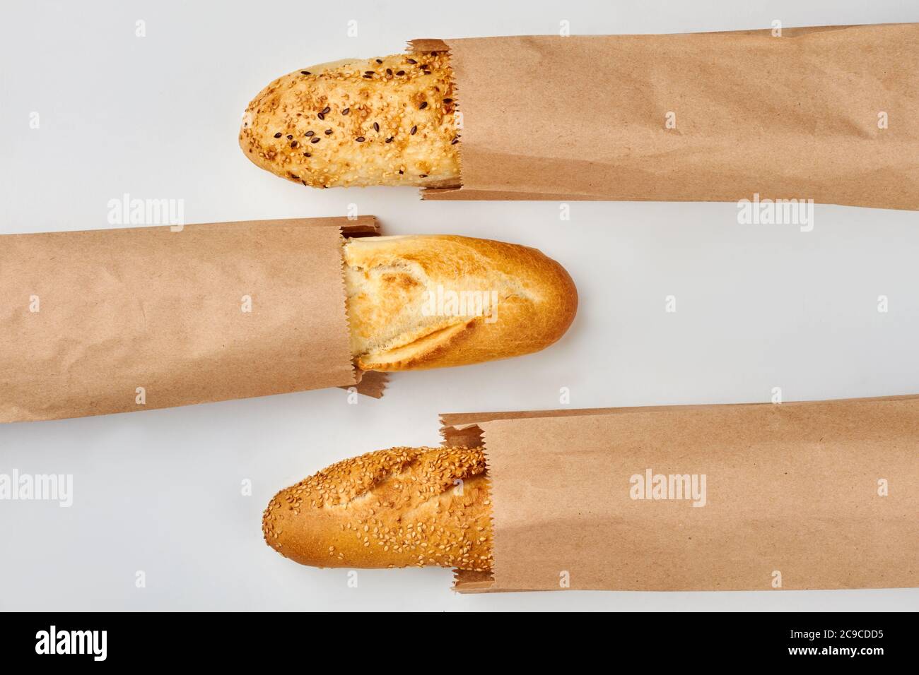 Wholegrain baguettes in paper bags Stock Photo - Alamy