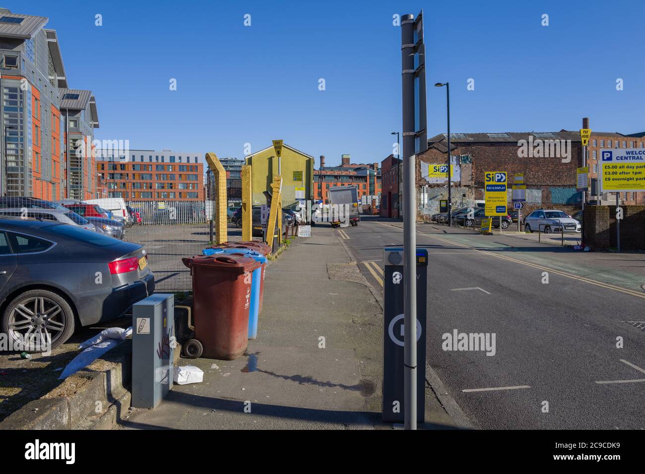 View down Port Street, Manchester, UK, showing new and old Manchester. Car parking on sites of demolished buildings. Stock Photo