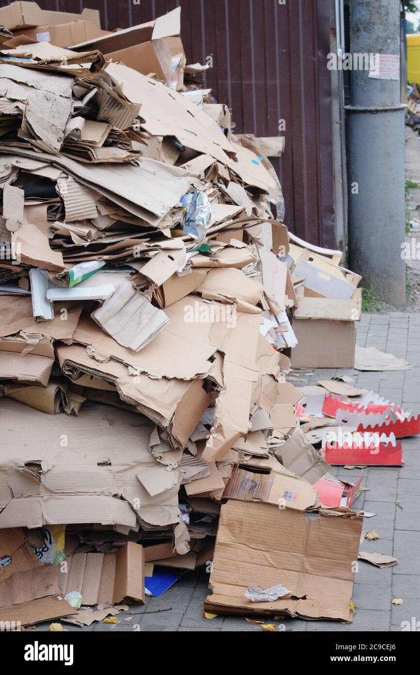 Cardboard and waste paper is collected and packaged for recycling. Pile of cardboard to be recycled. Urban Recycling. Stock Photo