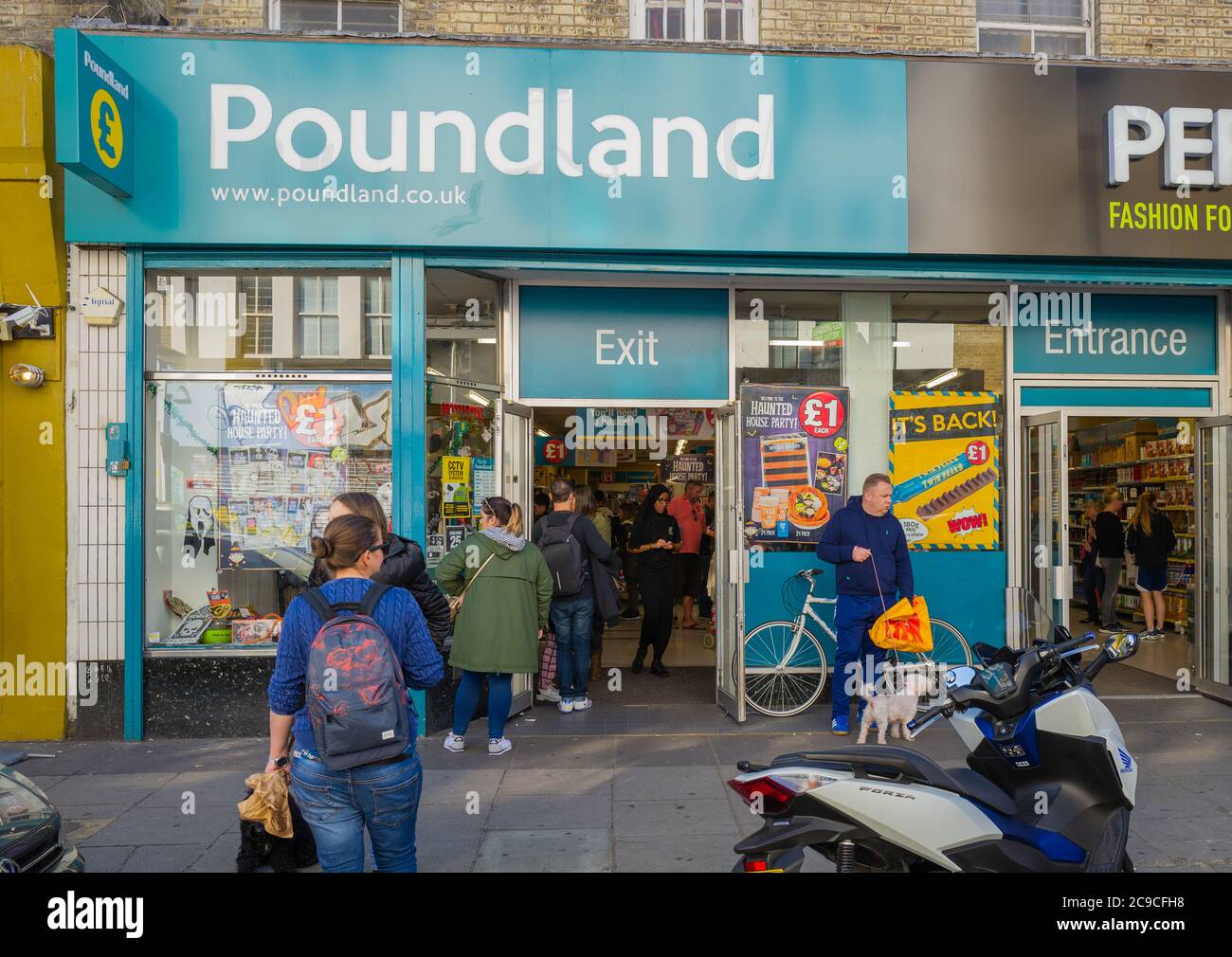 Entrance and Exit signs in exterior of Poundland shop, London, UK. Stock Photo