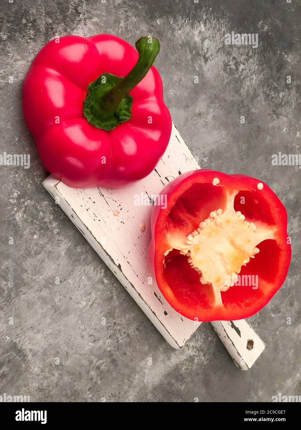 closeup halved red bell pepper on a cutting board Stock Photo - Alamy