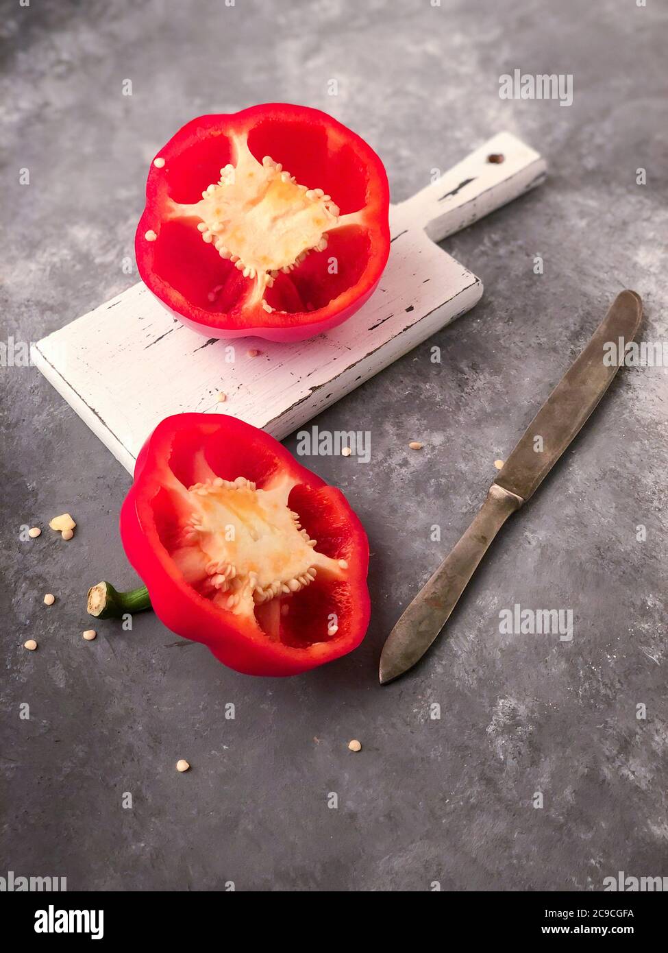 closeup halved red bell pepper on a cutting board Stock Photo - Alamy