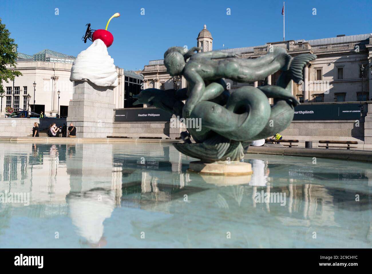 London, UK. 30th July, 2020. Photo taken on July 30, 2020 shows the Fourth Plinth sculpture titled 'The End' at Trafalgar Square in London, Britain. A new artwork by artist Heather Phillipson was unveiled Thursday on the Fourth Plinth in London's Trafalgar Square. Entitled THE END, the sculpture tops the Fourth Plinth with a giant swirl of whipped cream, a cherry, a fly and a drone that transmits a live feed of Trafalgar Square. Credit: Ray Tang/Xinhua/Alamy Live News Stock Photo